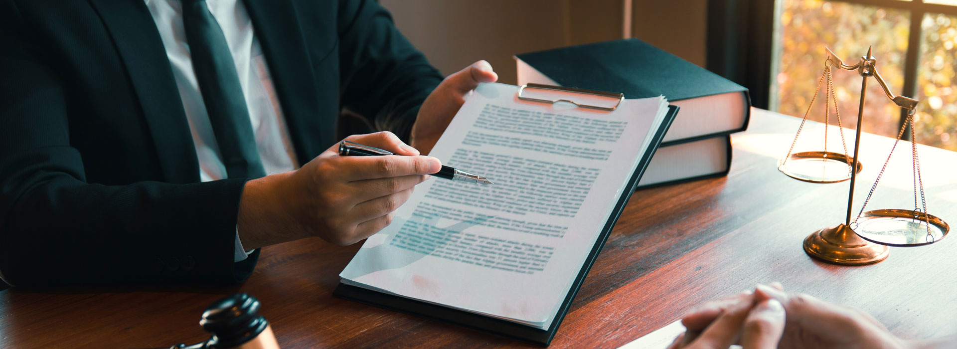 person pointing to paper with pen image